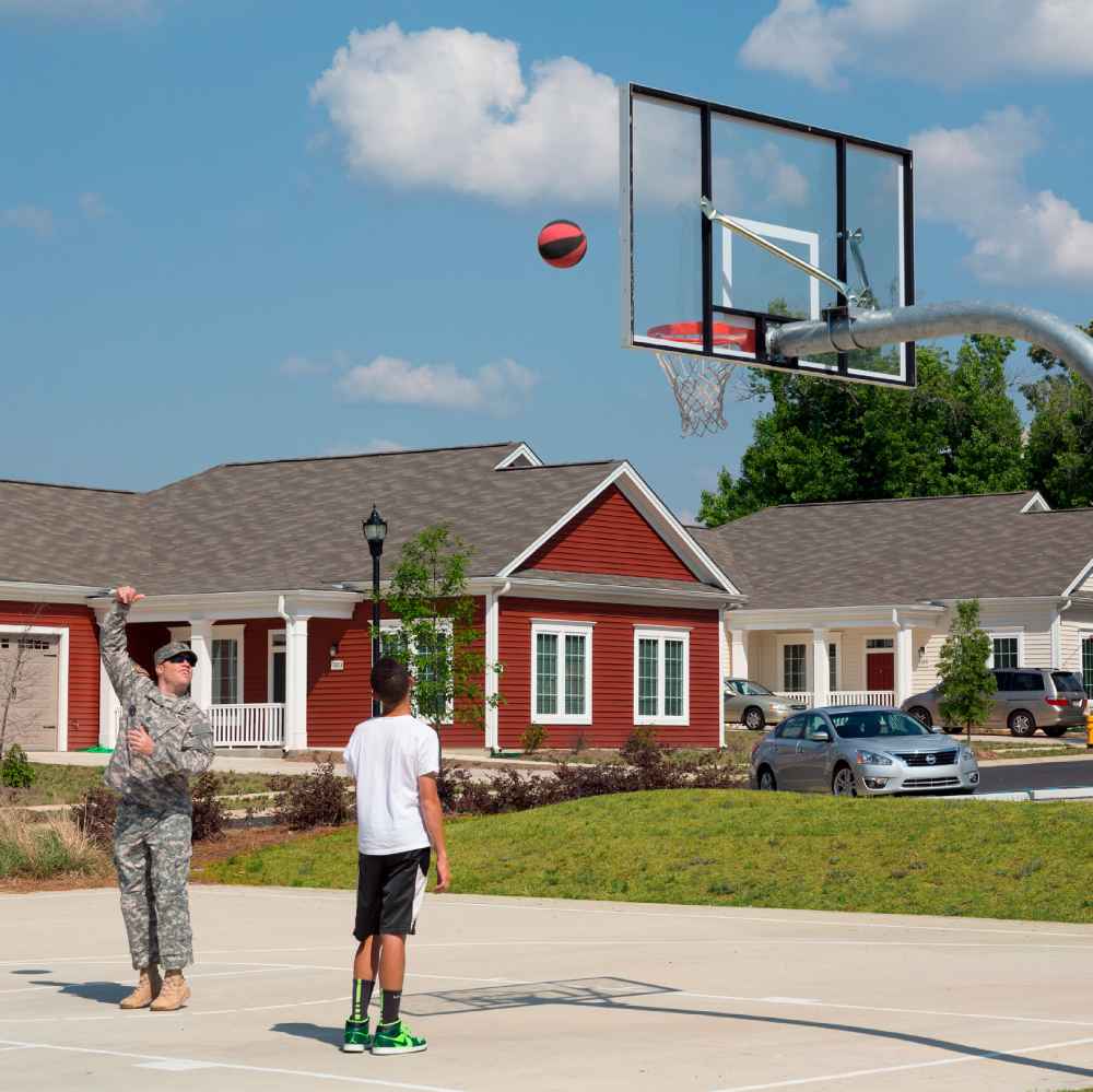 A father and son playing basketball at CBG’s Benning Family Housing community.